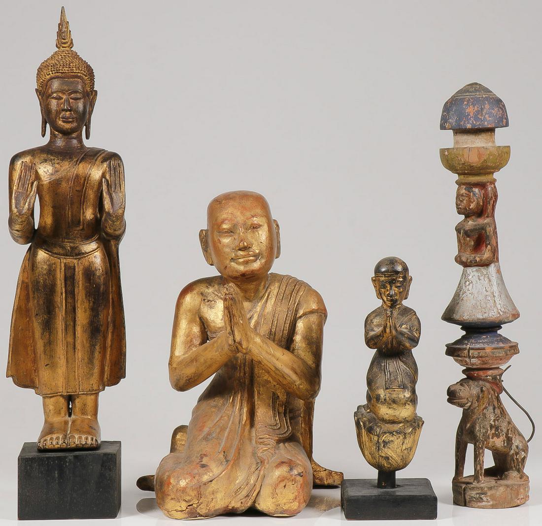 A GROUP OF BUDDHIST SCULPTURES: A GROUP OF BUDDHIST SCULPTURES. Comprising a standing gilt wood Thai Buddha with conforming wooden base, and two gilt wood kneeling Buddhist disciples. Together with an Indian door post. Greatest heig