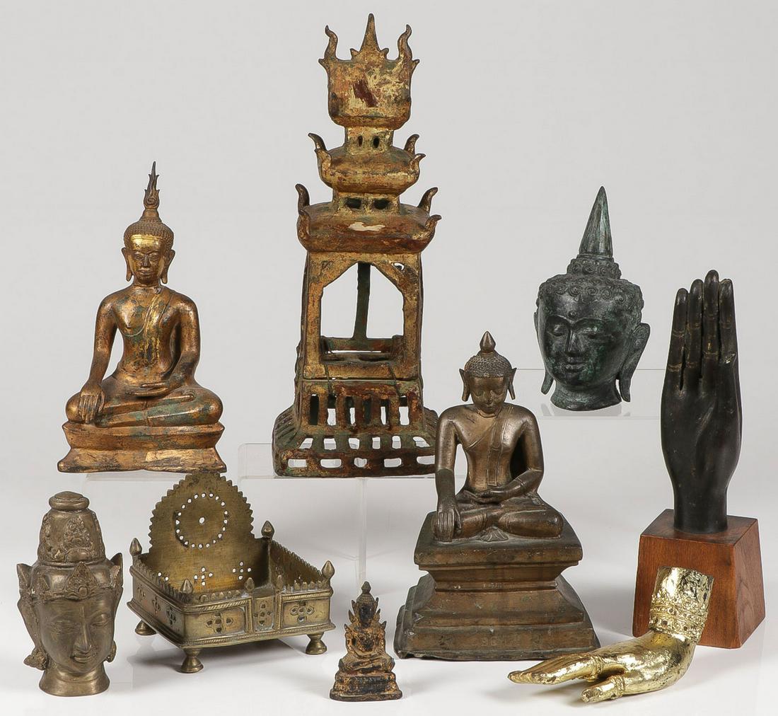 A GROUP OF NINE METAL BUDDHA RELATED ITEMS: A GROUP OF NINE METAL BUDDHA RELATED ITEMS. Comprising three seated Buddha figures, two Buddha busts, the figure of a hand attached to a wooden base, a gilded hand figure, a shrine, and a stand. Great