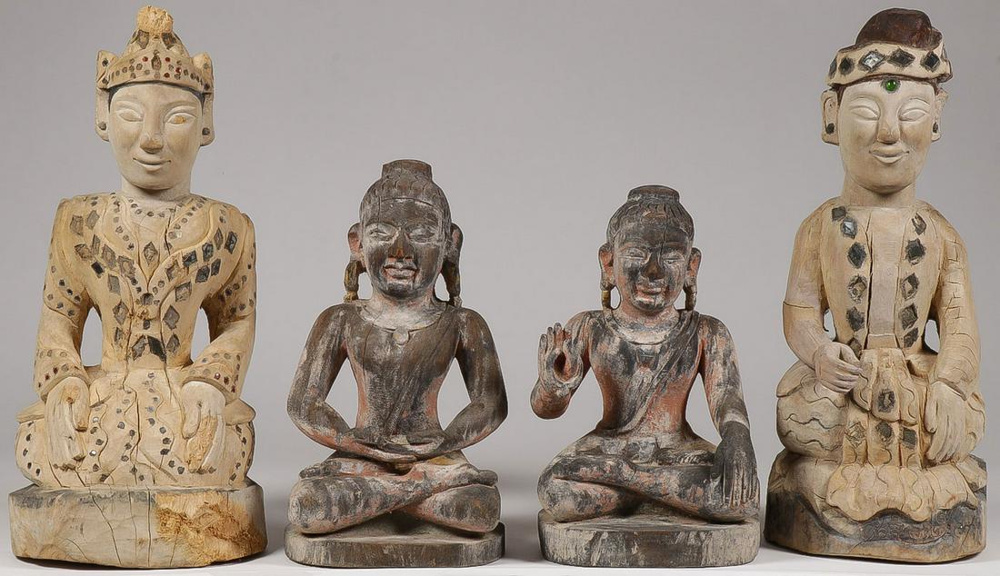 FOUR CARVED WOOD BUDDHA FIGURES: FOUR CARVED WOOD BUDDHA FIGURES. Comprising a pair of carved kneeling Buddha figures with inlaid glass decoration and a pair of carved seated Buddha figures. Greatest height 24 inches (61 cm). SHIPPIN