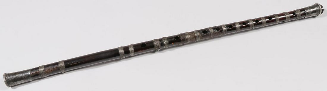 A TIBETAN WOOD FLUTE, 19TH CENTURY: A TIBETAN WOOD FLUTE, 19TH CENTURY. With silver mounted endcaps and wire banding, 24 inches (61 cm). SHIPPING NOTICE: Jackson's is your sole and only source for one stop packing and shipping. W