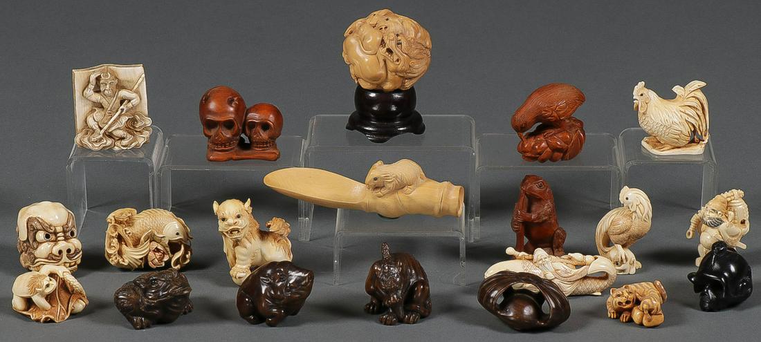 A GROUP OF TWENTY CARVED NETSUKES: A GROUP OF 20 CARVED NETSUKES. Comprising carved netsukes of different materials in various forms including skulls animals, mythological creatures, and others all intricately carved in full round some
