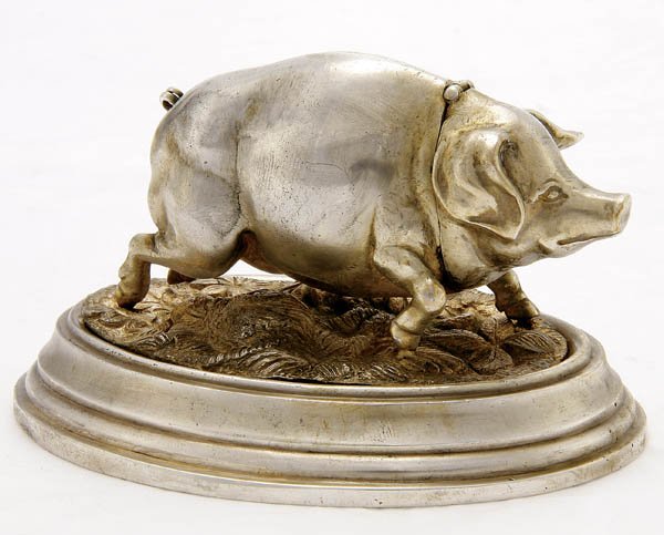 A SILVER FIGURAL MATCH HOLDER in the form of a tr