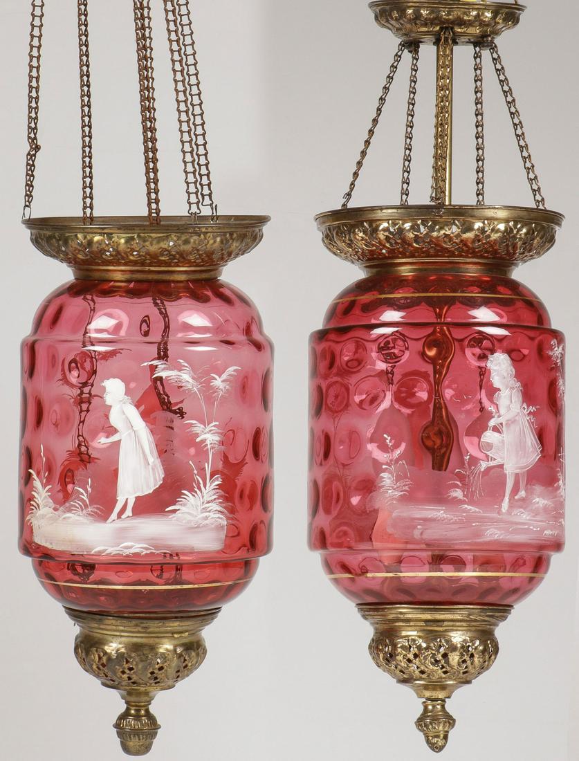 TWO RARE MARY GREGORY CRANBERRY LAMPS: TWO RARE MARY GREGORY CRANBERRY LAMPS. Comprising two large and impressive Bohemian (AKA Mary Gregory) enamel decorated cranberry thumbprint glass shades with similar brass mountings. Each of the cyli