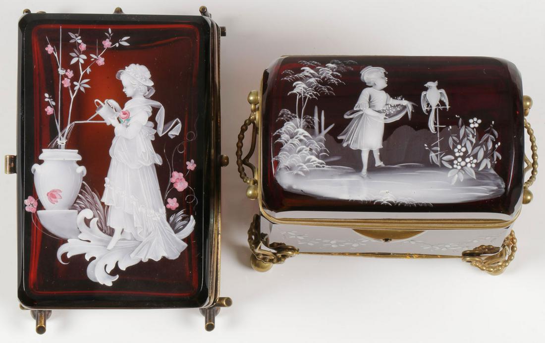 PAIR EXCEPTIONAL MARY GREGORY BOXES, C. 1890: PAIR EXCEPTIONAL MARY GREGORY BOXES, C. 1890. Comprising two finely decorated Bohemian (AKA Mary Gregory) enamel decorated ruby red glass boxes. One of casket form with dome hinged lid painted with yo