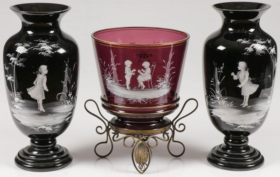THREE MARY GREGORY VASES, C. 1890: THREE MARY GREGORY VASES, C. 1890. Comprising three individual Bohemian (AKA Mary Gregory) enamel decorated vases including a large amethyst vase or jardinière in wire frame with gilt banding and fin