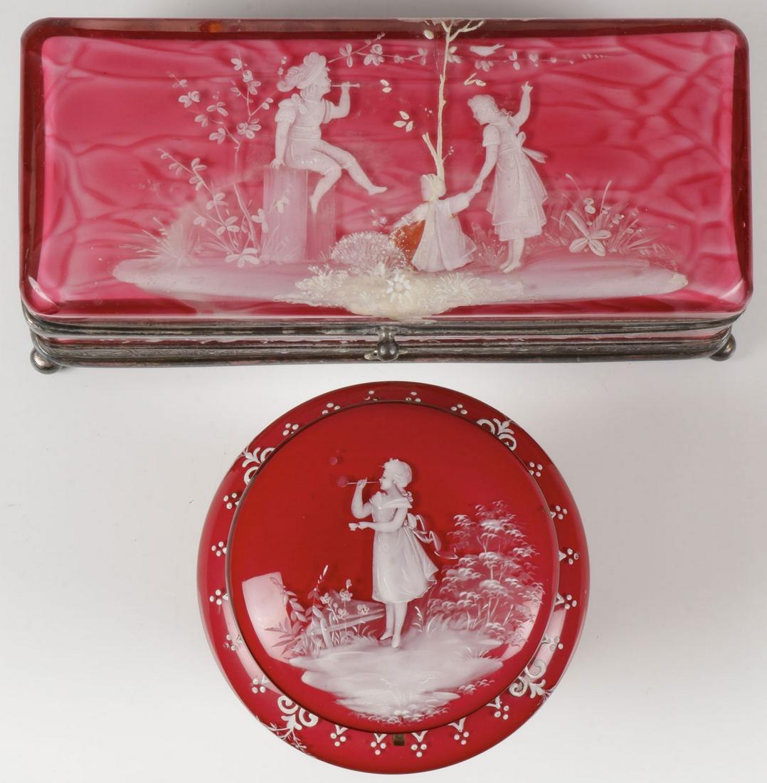 A PAIR OF MARY GREGORY BOXES, C. 1890: A PAIR OF MARY GREGORY BOXES, C. 1890. Comprising a pair of Bohemian (AKA Mary Gregory) enamel decorated boxes consisting of a large glove box in red marbleized glass, the hinged lid enameled with chi