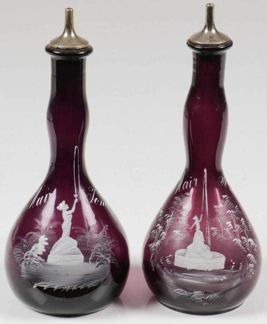 TWO RARE MARY GREGORY BARBER BOTTLES, C. 1890: TWO RARE MARY GREGORY BARBER BOTTLES, C. 1890. Comprising two Bohemian (AKA Mary Gregory) enamel decorated amethyst glass barber bottles. Both depicting women in a fountain set in a wooded landscape, 