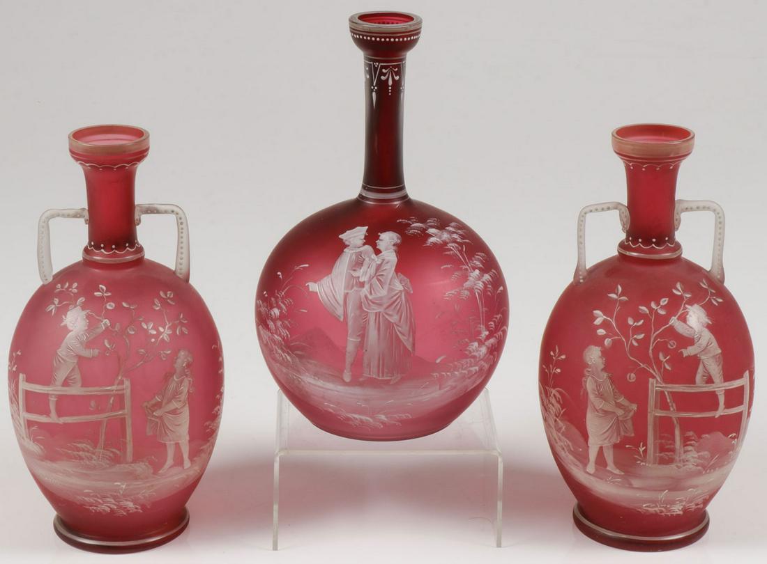 MARY GREGORY CRANBERRY GLASS VASES, C. 1900: MARY GREGORY CRANBERRY GLASS VASES, C. 1900. Comprising three individual pieces of Bohemian (AKA Mary Gregory) enamel decorated cranberry satin glass vases including a matching pair of traditional Gre
