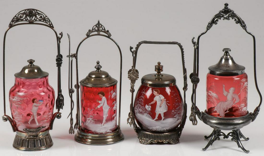 FOUR MARY GREGORY CRANBERRY PICKLE CASTERS: FOUR MARY GREGORY CRANBERRY PICKLE CASTERS. Comprising four individual Bohemian (AKA Mary Gregory) cranberry enamel decorated pickle casters of various shapes and sizes, including two thumbprint examp