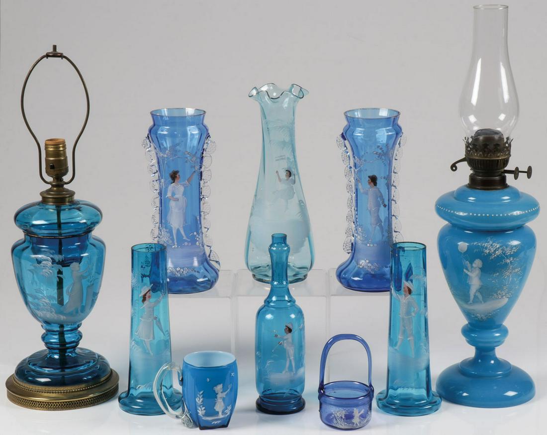 10 PIECES MARY GREGORY GLASSWARE: 10 PIECES MARY GREGORY GLASSWARE. Comprising 10 individual pieces Bohemian (AKA Mary Gregory) enamel decorated blue glass objects including two pair of matching vases, one with pinched glass applied h