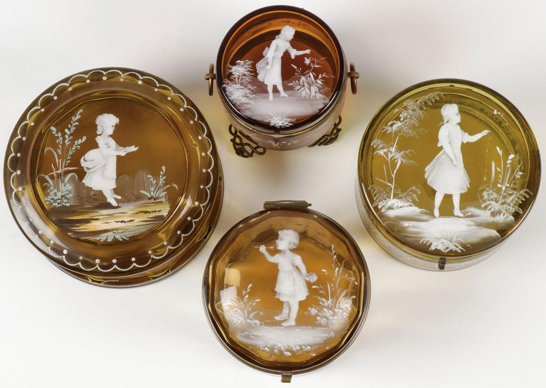 FOUR MARY GREGORY BOXES, C. 1890: FOUR MARY GREGORY BOXES, C. 1890. Comprising four Bohemian (AKA Mary Gregory) enamel decorated amber glass round boxes, the hinged lid of each finely decorated with scenes of children and the sides wi