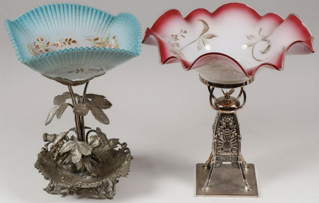 TWO VICTORIAN SILVER-PLATED CENTERPIECES, 19TH C: TWO VICTORIAN SILVER-PLATED CENTERPIECES, 19TH C. Comprising two ornate silver-plate centerpiece stands set with art glass bowls including one example, the base of grape-leaf form resting on four grap