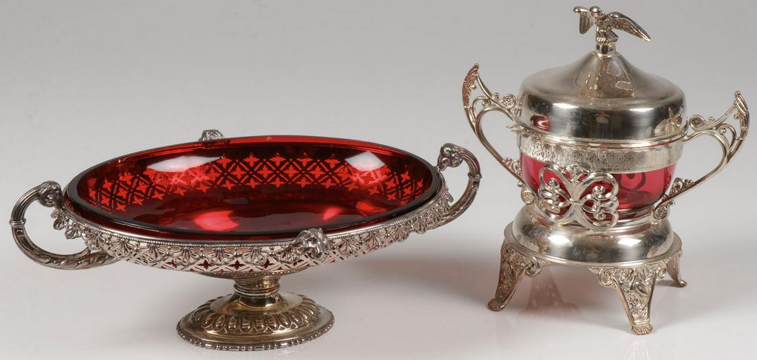 PAIR SILVER-PLATED TABLEWARE W/ RUBY INSERTS: PAIR SILVER-PLATED TABLEWARE W/ RUBY INSERTS. Comprising an interesting silver-plated oval frame with ruby red glass insert, the oval base supporting an oval frame with lattice work border and ornate 