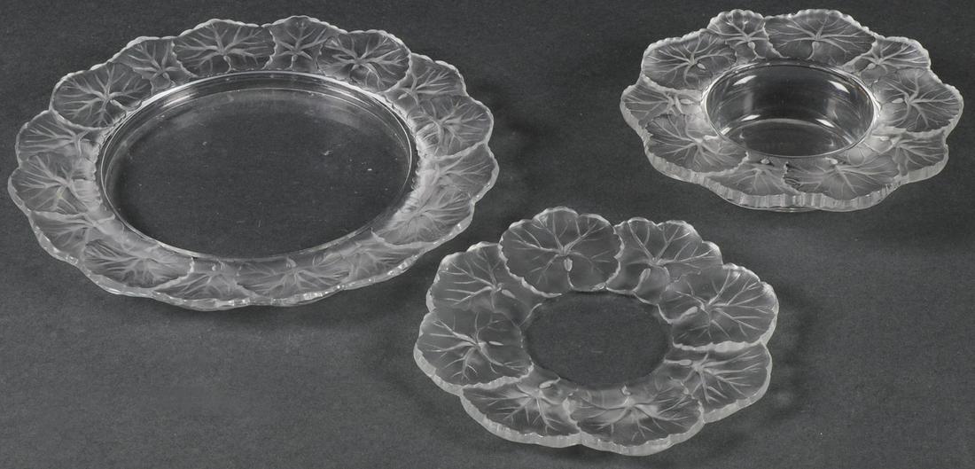 THREE LALIQUE LILY PAD DISHES: THREE LALIQUE LILY PAD DISHES. Including an 8.25-inch plate, a 6-inch diameter bowl, and a 6-inch diameter underplate. SHIPPING NOTICE: Jackson's is your sole and only source for one stop packin