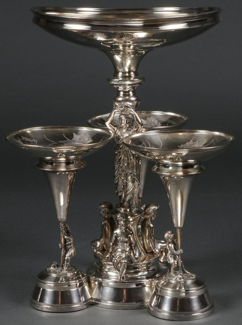 ORNATE VICTORIAN CENTERPIECE, C. 1880: ORNATE VICTORIAN CENTERPIECE, C. 1880. Comprising a large and impressive ornate four-bowl silver-plated centerpiece, Meriden Britannia Company. The trefoil base with three lobes, each set with a finel