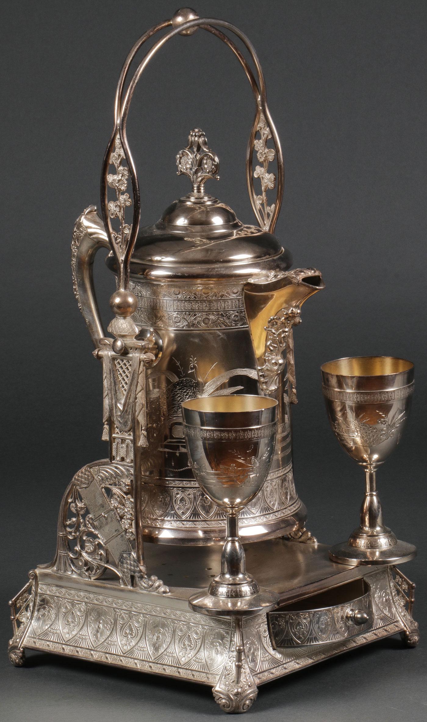 AN OUTSTANDING AESTHETIC ICE WATER PITCHER: AN OUTSTANDING AESTHETIC ICE WATER PITCHER. Comprising a large and impressive E.G. Webster & Sons silver-plated aesthetic ice water pitcher, circa 1880. The slightly flared square base resting on four