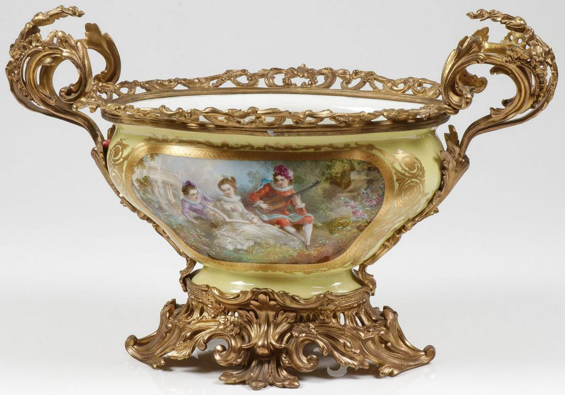 FINE ORMOLU MOUNTED PORCELAIN CENTERPIECE, 19TH C: FINE ORMOLU MOUNTED PORCELAIN CENTERPIECE, 19TH C. Comprising a large shaped bowl with spread foot, the sides with gilt decorated shaped cartouches on a yellow ground, each with hand-painted scenes, i