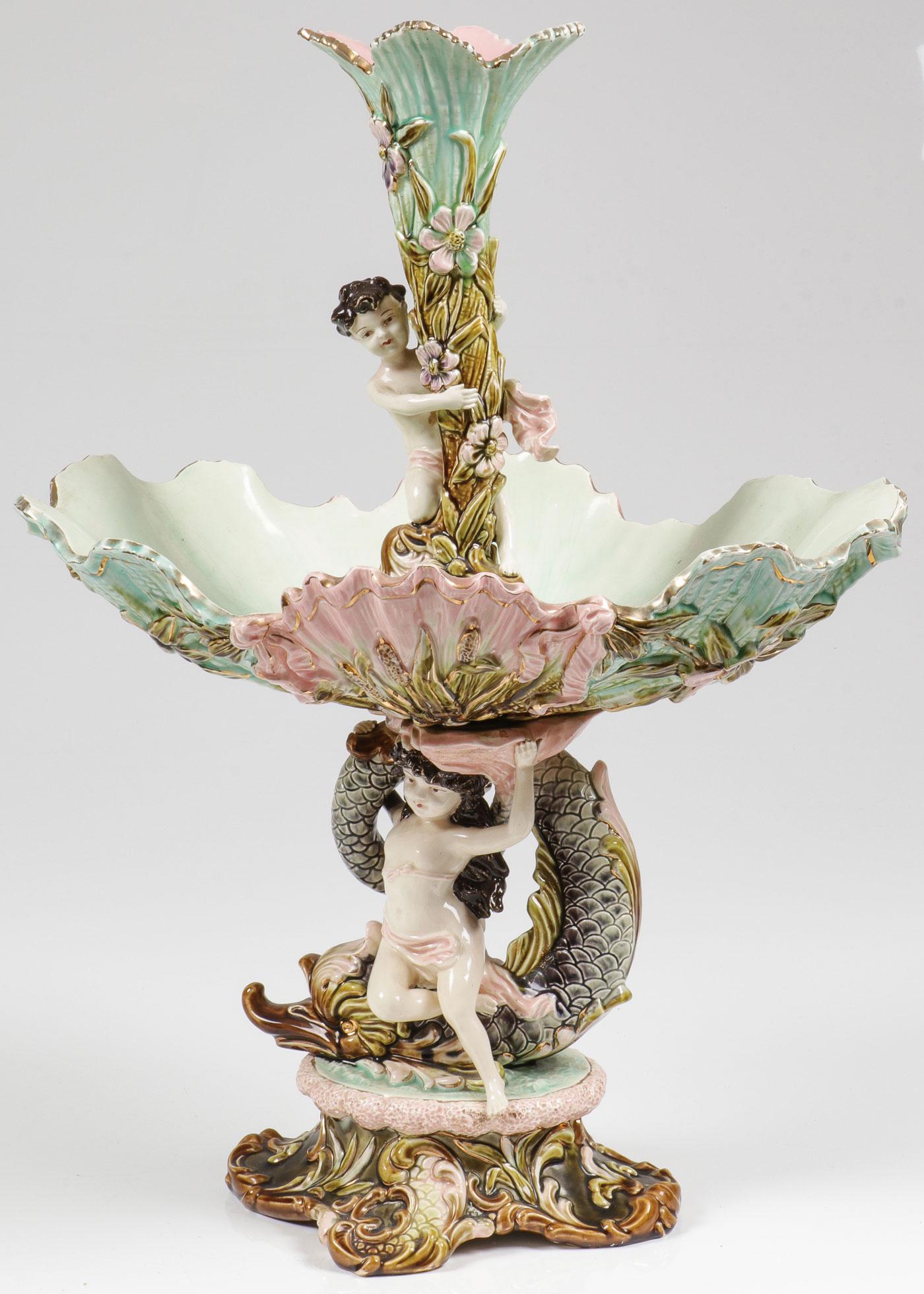 EICHWALD MAJOLICA FIGURAL CENTERPIECE, C. 1900: EICHWALD MAJOLICA FIGURAL CENTERPIECE, C. 1900. Comprising a large and impressive Majolica centerpiece, the quatrefoil raised base supporting a dolphin and mermaid beneath a shell-form decorated with 