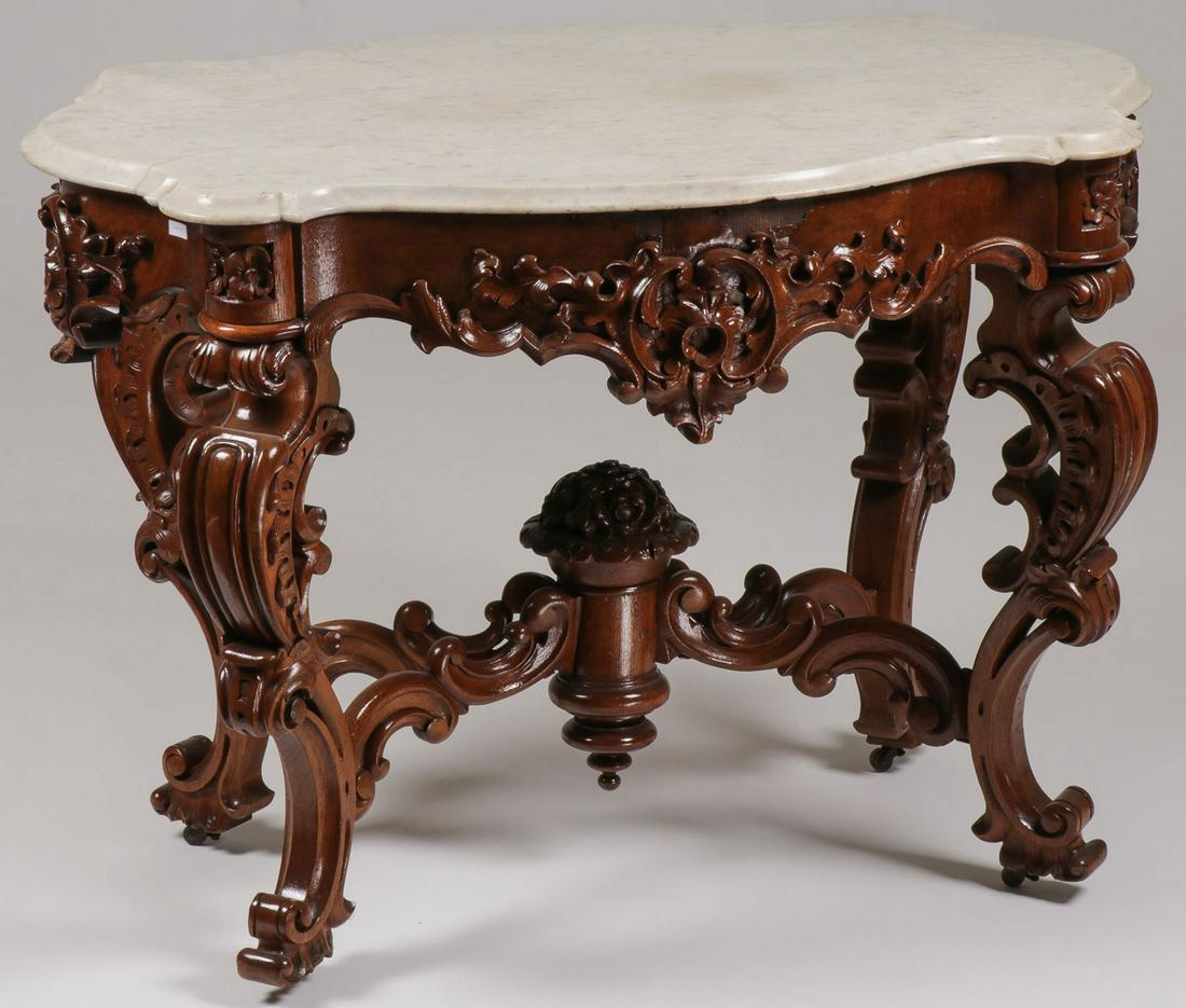 FINE ROCOCO REVIVAL MARBLE TOP TABLE, 19TH C: FINE ROCOCO REVIVAL MARBLE TOP TABLE, 19TH C. Comprising an impressive ornately carved table with tortoise form marble over a conforming frieze with ornate scroll and floral corners raised on similarl