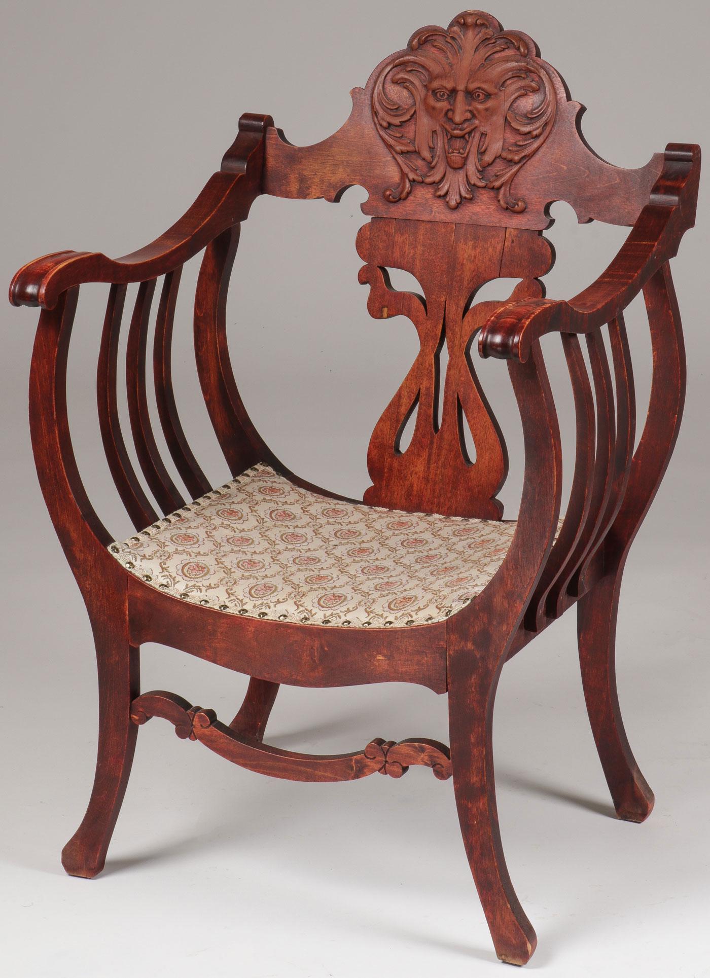 A PAIR OF VINTAGE SIDE CHAIRS: A PAIR OF VINTAGE SIDE CHAIRS. Comprising a stained campaign chair, the backrest with anthropomorphic face, height 37.25 inches, together with a Rococo Revival style walnut side chair with impressive 