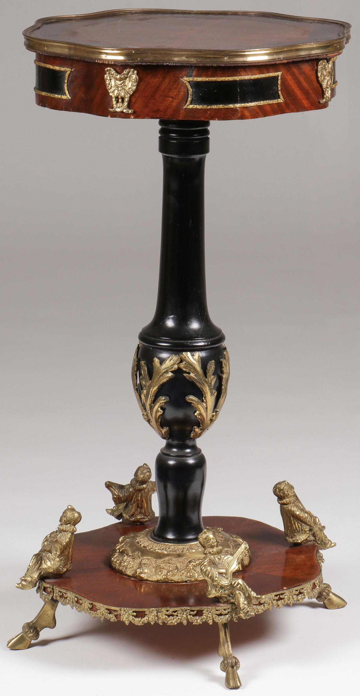 ORMOLU EBONIZED FIGURAL STAND: ORMOLU EBONIZED FIGURAL STAND. Comprising an attractive veneered mahogany stand on shaped base resting on four hooved legs, and set with four cast musical harlequins with ebonized baluster pedestal su