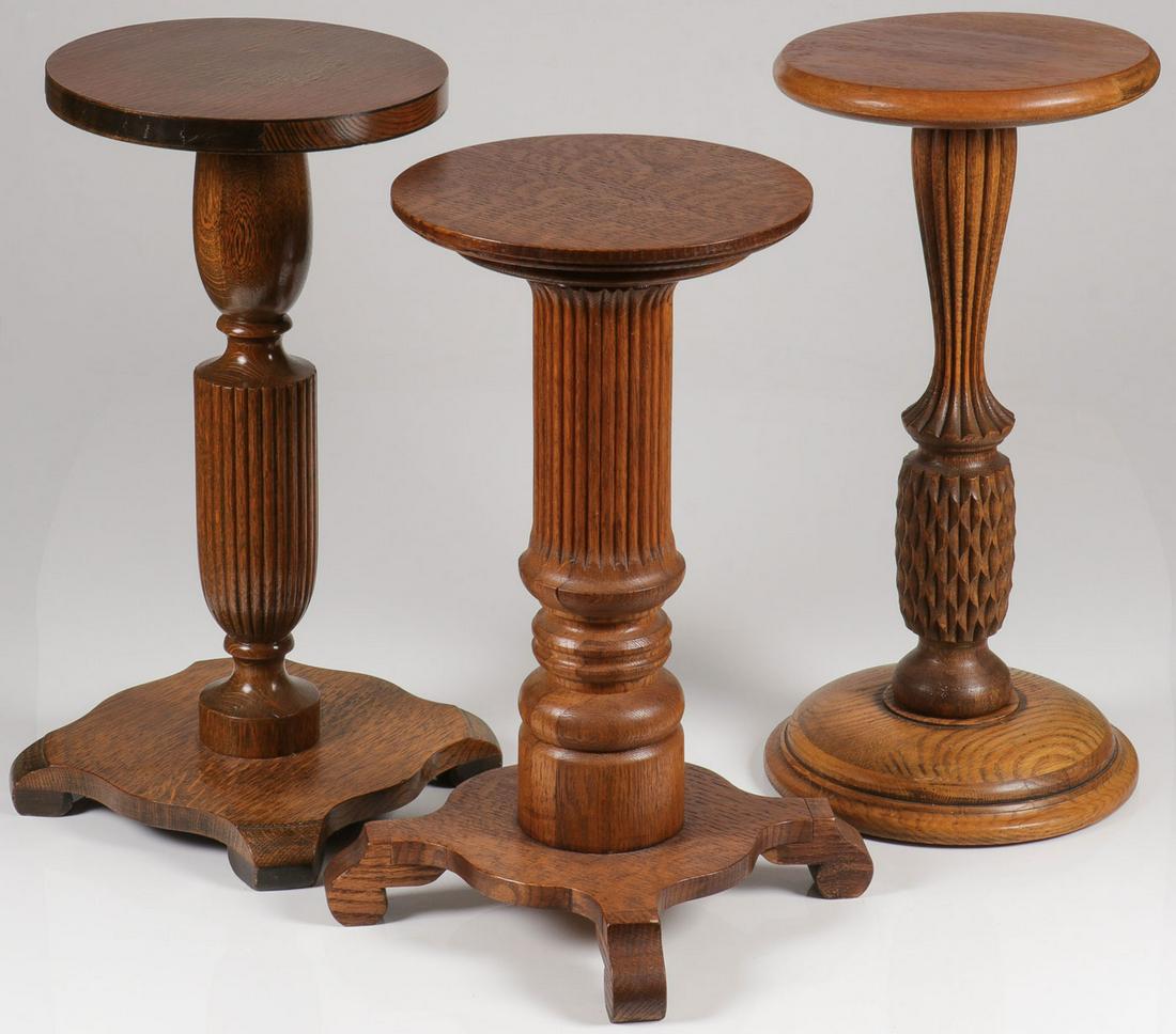 THREE OAK PEDESTALS: THREE OAK PEDESTALS. Comprising three room ready American carved oak pedestals, each with fluted central column, greatest height 24 inches. SHIPPING NOTICE: Jackson's is your sole and only source