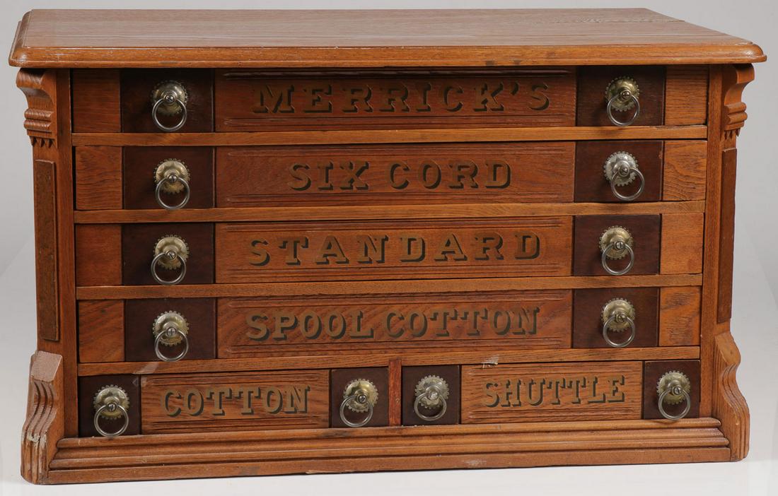 A MERRICK'S OAK SPOOL CABINET: A MERRICK'S OAK SPOOL CABINET. Comprising a large ornate and impressive Merrick's six-drawer spool cabinet, each drawer with gilt lettering and the sides displaying matching later Merrick's spread win