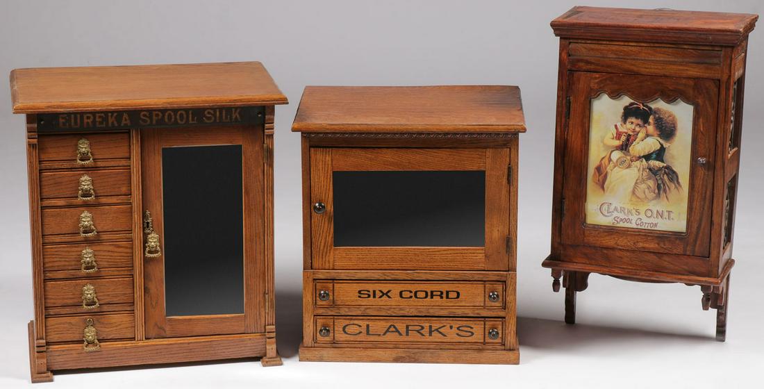 TWO VINTAGE OAK SPOOL CASES: TWO VINTAGE OAK SPOOL CASES. Comprising a large Eureka counter top cabinet style spool case with six drawers on left side and mirrored door on right side, height 23.5 inches, width 21.5 inches, depth