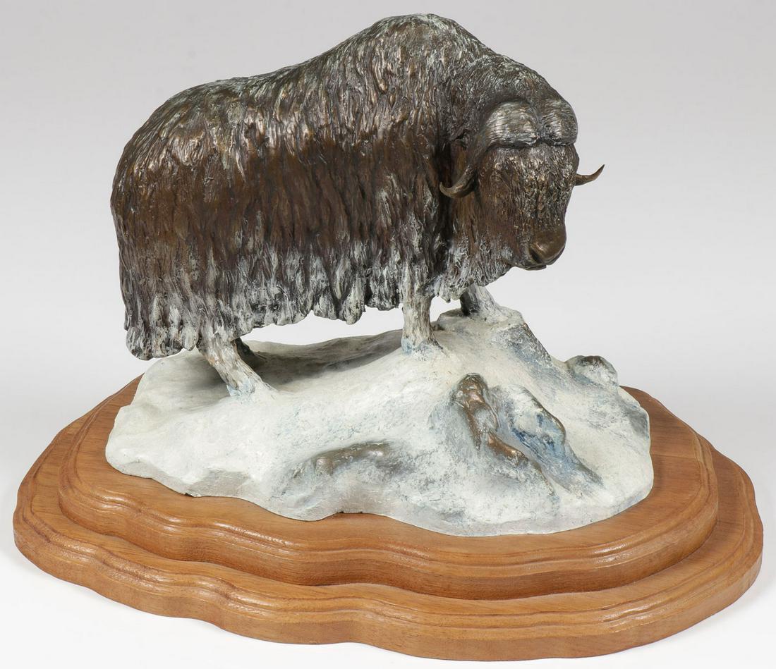 A POLYCHROMED BRONZE MUSK OX: A POLYCHROMED BRONZE MUSK OX. Comprising a finely sculpted Musk Ox on rocky snow-covered outcrop. Realistically sculpted in full round with excellent details by Iowa artist Russell Christensen. Signed