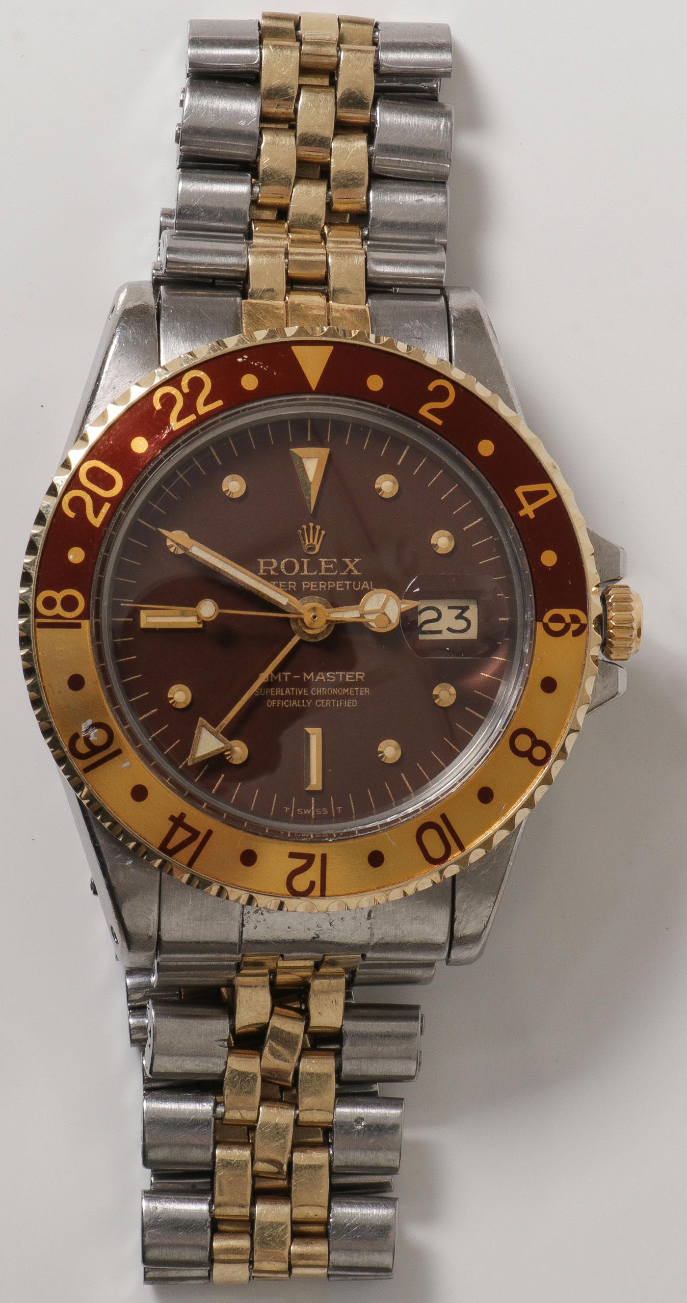 A ROLEX GMT MASTER "ROOT BEER" 1971: A ROLEX GMT MASTER "ROOT BEER" 1971. Comprising a Rolex "Oyster Perpetual GMT Master, superlative Chronometer" with two-tone "Root beer" bidirectional revolving bezel for double time zone, brown dial