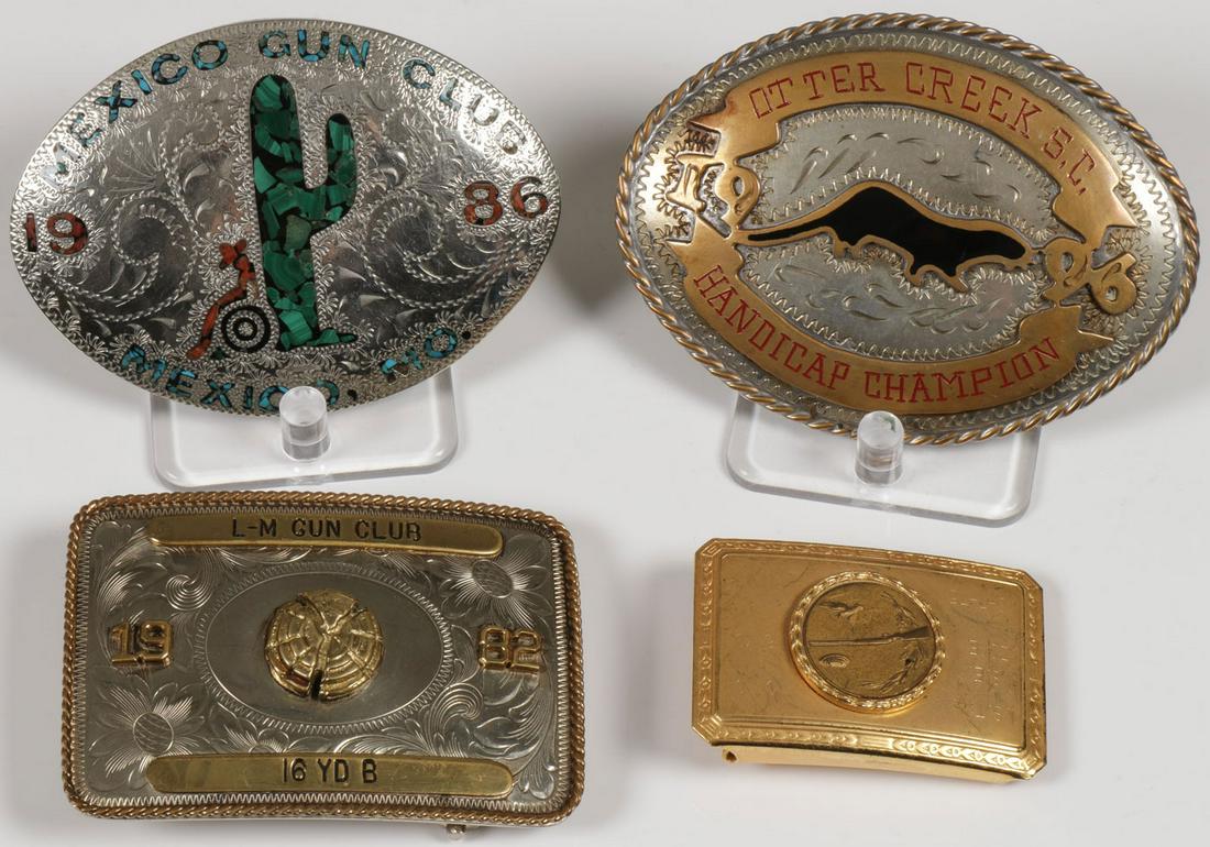 THREE SHOOTING TROPHY BUCKLES: THREE SHOOTING TROPHY BUCKLES. Comprising three individual trophy belt buckles given for skeet and trap shooting including an oval and enamel specimen from Otter Creek, S.C., maker's marked. J. Tedder