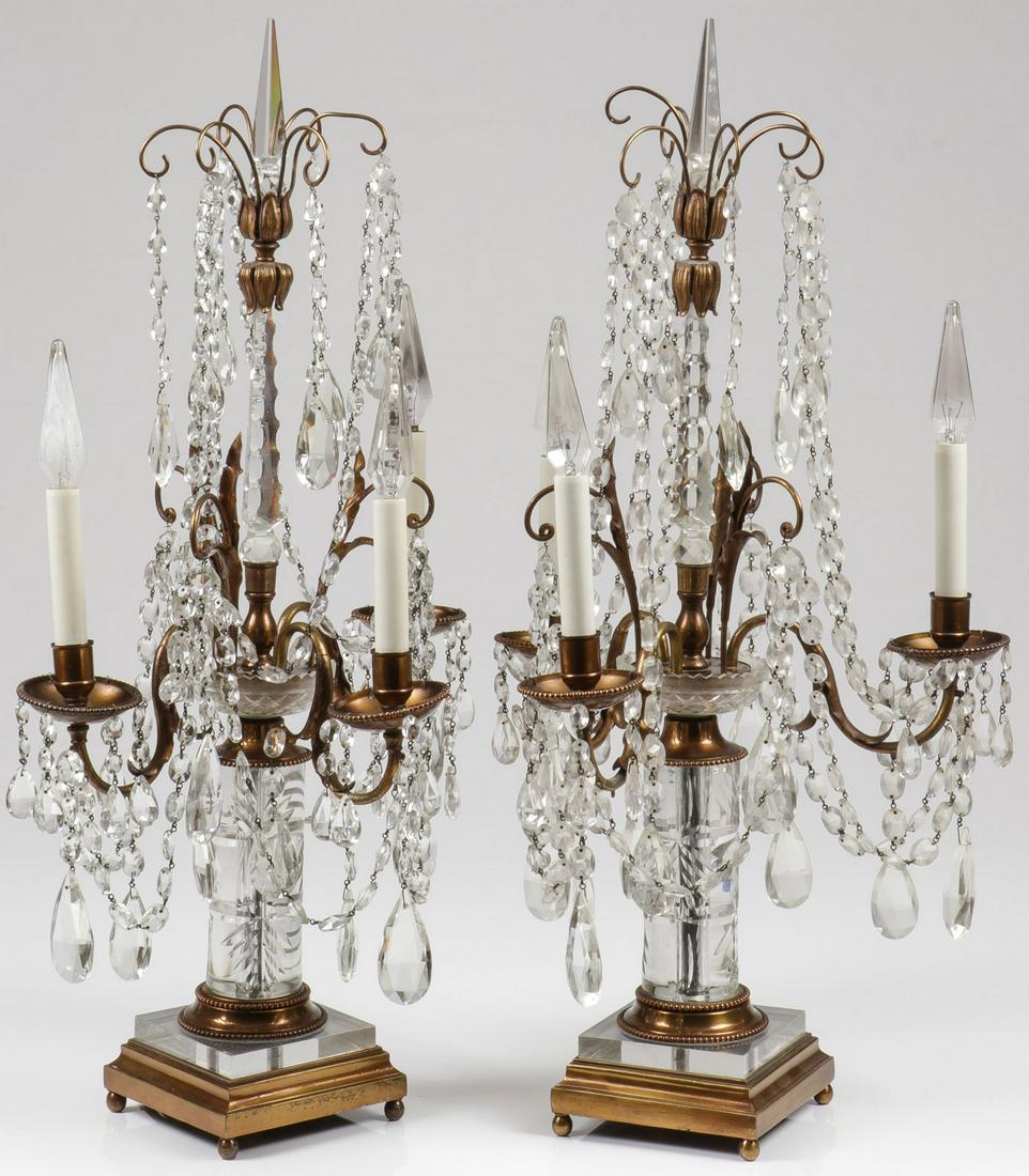 A PAIR OF CRYSTAL MANTLE LUSTERS, 19TH C: A PAIR OF CRYSTAL MANTLE LUSTERS, 19TH C. Comprising a good pair of matching cut crystal and bronze mantel lusters, set on a stepped square base on ball feet, with crystal platform upon which rests a