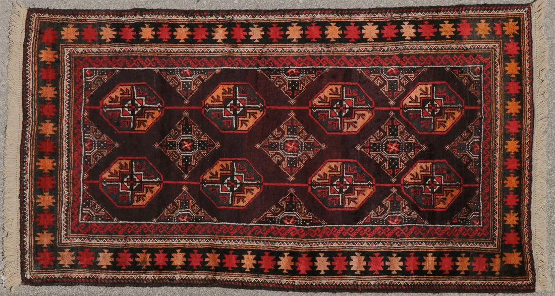 GROUP THREE SEMI-ANTIQUE AFGHAN RUGS: GROUP THREE SEMI-ANTIQUE AFGHAN RUGS. Comprising an Ersari pattern rug, circa 1950, centered with 8 "elephant foot" medallions on a dark blue field with geometric border, 40 inches x 65 inches (101.5