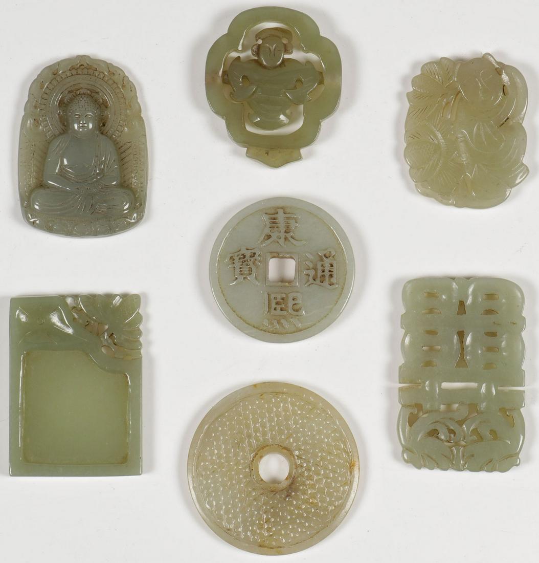 A GROUP OF SEVEN CHINESE CARVED JADE PENDANTS: A GROUP OF SEVEN CHINESE CARVED JADE PENDANTS. Comprising a finely carved solid form pendant of a seated Buddhist deity, two disc form pendants, and four pierced carved examples of various shape and d