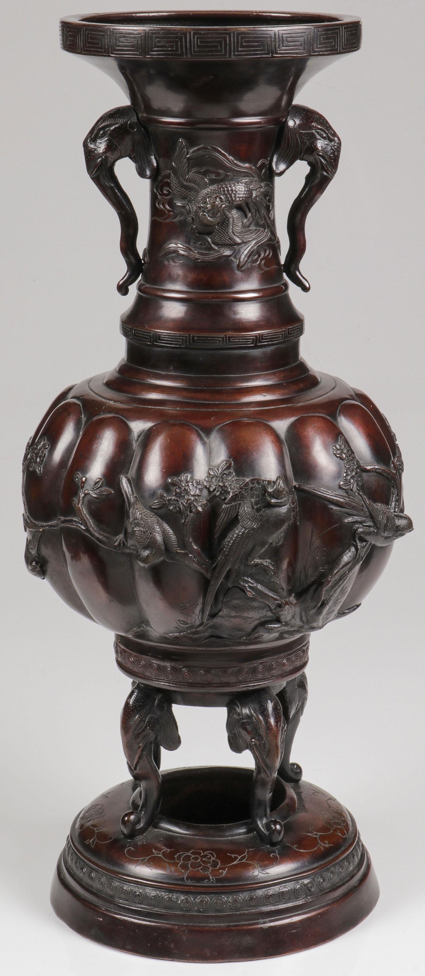 LARGE JAPANESE BRONZE VASE, MEIJI: LARGE JAPANESE BRONZE VASE, MEIJI. Comprising a large and impressive patinated bronze vase on circular base resting on four elephant head formed feet supporting a ribbed bulbous form vase with exquisi