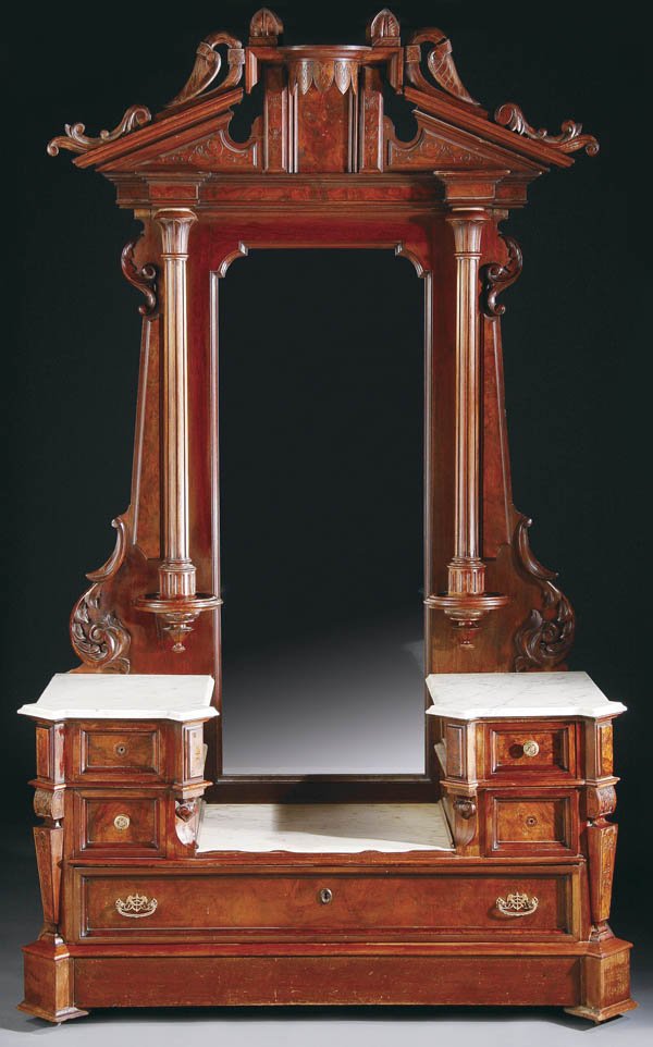 AN AMERICAN CARVED WALNUT DRESSER