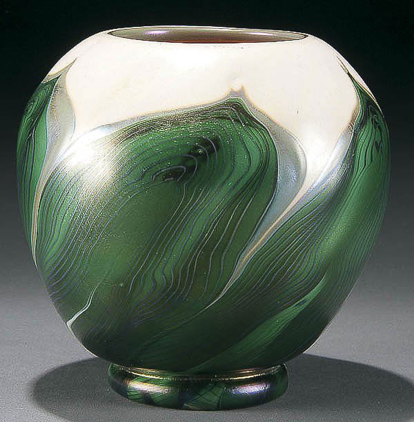 L.C. TIFFANY FAVRILE GLASS PULLED FEATHER VASE: A FINE L.C. TIFFANY FAVRILE GLASS "PULLED FEATHER" VASE early 20th century, of spherical form with green silvery tipped pulled feathers over an opal ground with iridized gold interior. Inscribed "L.C.