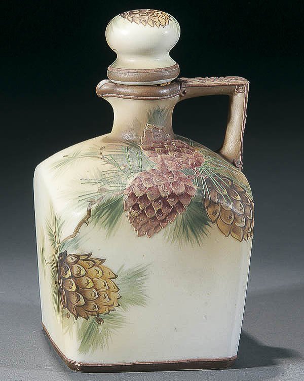 A NIPPON MORIAGE WHISKEY JUG early 20th century, : A NIPPON MORIAGE WHISKEY JUG early 20th century, with raised decorated pinecones. Green "M in wreath" mark. Height 7.25 inches (18.5 cm). Estimate $250-$450
