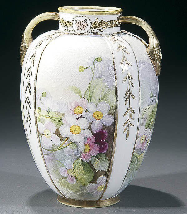 NIPPON TAPESTRY HANDLED PORCELAIN VASE: A VERY FINE NIPPON TAPESTRY HANDLED PORCELAIN VASE early 20th century, with hand painted florals in four panels on a frosted ice texture ground. Green "M in wreath" mark. Height 6.75 inches (17 cm). E