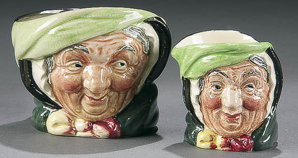 A TWO PIECE ROYAL DOULTON "SAIREY GAMP" SET circa: A TWO PIECE ROYAL DOULTON "SAIREY GAMP" SET circa 1941, comprising of a "Sairey Gamp" sugarbowl and a toothpick holder first with green mark, second with dark mark. Height 2.25-2.75 inches. Estimate $