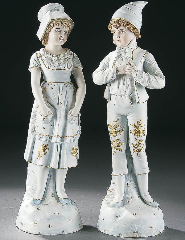 TWO BLUE BISQUE VICTORIAN FIGURES HIGHLIGHTED WIT: TWO BLUE BISQUE VICTORIAN FIGURES HIGHLIGHTED WITH GOLD, 19th century, one each of a small boy and girl, ink stamped RW. Height 17 inches. Estimate $100-$200