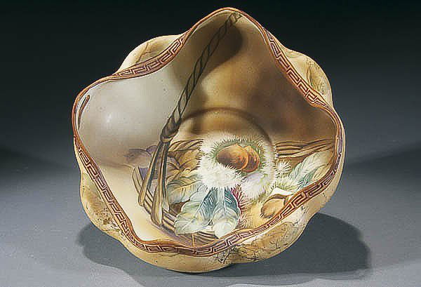 A NIPPON MOLDED TWO-HANDLED NUT BOWL circa 1910 w: A NIPPON MOLDED TWO-HANDLED NUT BOWL circa 1910 with scalloped rim and raised geometric design, green "M in wreath" mark. Diameter 9 inches. Estimate $75-$150