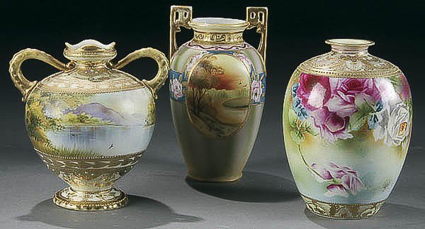A GROUP OF THREE NIPPON VASES 20th century consis: A GROUP OF THREE NIPPON VASES 20th century consisting of a pair of two-handled scenic vases with raised gilt enameling together with a floral decorated vase. Green "M in wreath", blue "maple leaf" mar