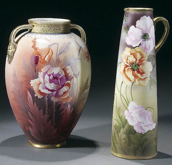 A PAIR OF HANDPAINTED NIPPON PORCELAIN early 20th: A PAIR OF HANDPAINTED NIPPON PORCELAIN early 20th century consisting of a two-handled floralized vase and a handled pitcher with stylized floral decorations. Both with raised gilt, Green "M in wreath"