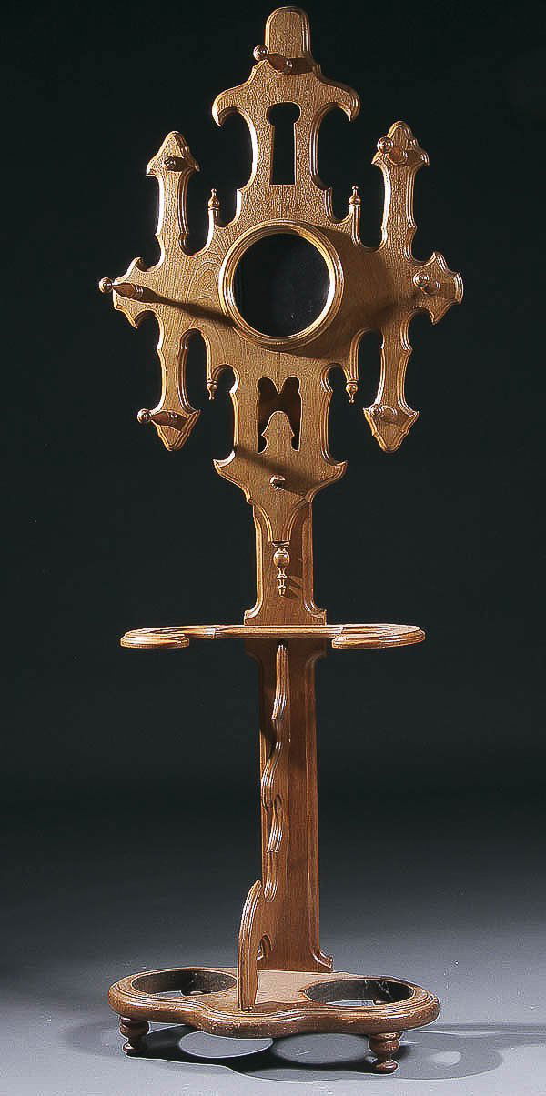 A VICTORIAN WALNUT HALL TREE with central mirror: A VICTORIAN WALNUT HALL TREE with central mirror flanked by coat hooks raised above umbrella and cane holders with scalloped supports. Height 83 inches, width 25 inches, depth 15 inches. Estimate $300