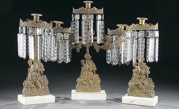 VICTORIAN GILT BRONZE & CUT PRISM GARNITURE: A VICTORIAN 3-PIECE GILT BRONZE & CUT PRISM GARNITURE mid 19th century, with sculpted romantic scene of a couple courting. Height 14.5 inches to 17 inches. Estimate $200-$400