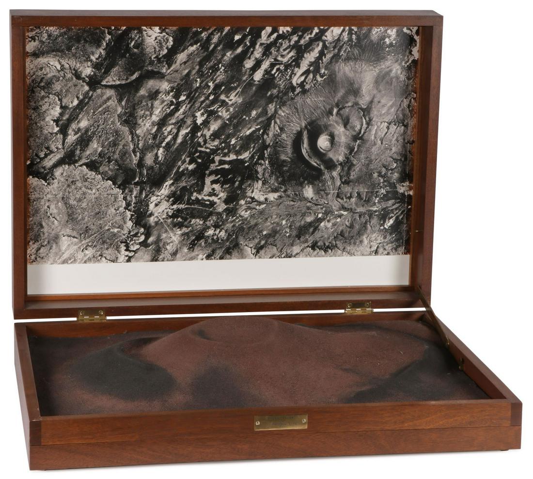 IMPORTANT JAMES TURRELL RODEN CRATER: JAMES TURRELL (American b. 1943-)Roden Crater - 1986Philippine mahogany box with fiberglass topographical model of Roden Crater, dirt from the site, folio with nine photographs and text sheets. Lacki
