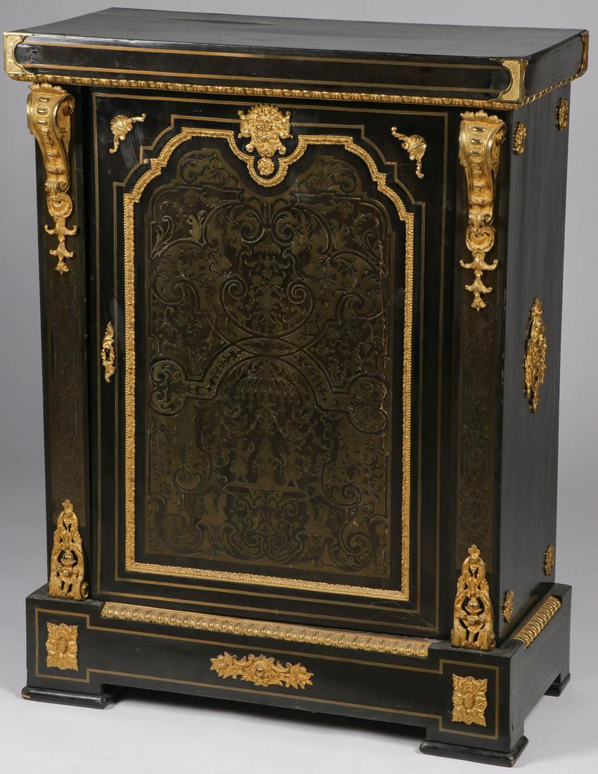 FRENCH EBONIZED BOULLE CABINET: FRENCH EBONIZED BOULLE CABINET. The ebonized body overall mounted with finely cast gilt bronze (ormolu) decorative elements and banding, and the door faced with an elaborate Boulle panel. Height 42.75