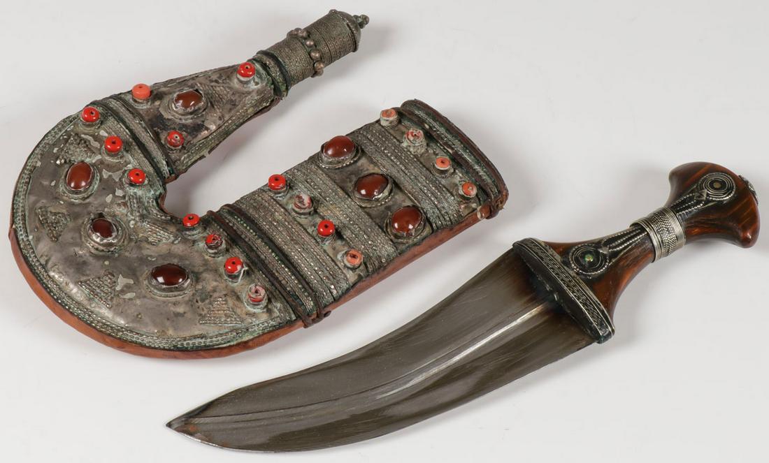 AN ATTRACTIVE JANBIYA: AN ATTRACTIVE JANBIYA. Of traditional form with horn handle and sheath mounted with coral beads and carnelian. Length 12 inches (31 cm). SHIPPING NOTICE: Jackson's is your sole and only s