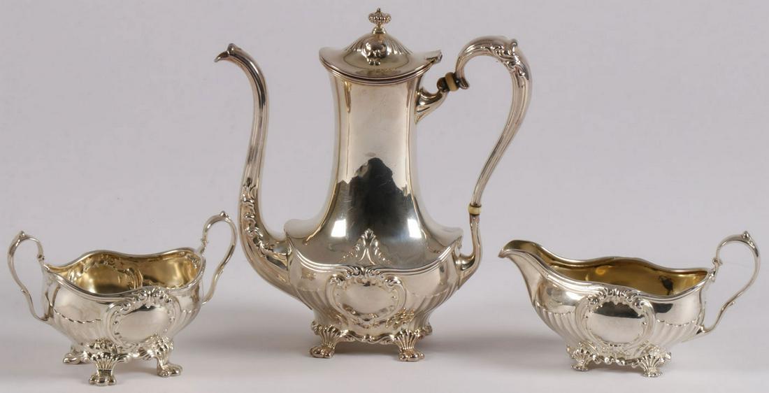 STERLING SILVER TEA SERVICE HESS & CULBERTSON: STERLING SILVER TEA SERVICE HESS & CULBERTSON. Comprising a three piece sterling silver tea service consisting of a teapot with hinged lid together with matching creamer and sugar each piece resting o